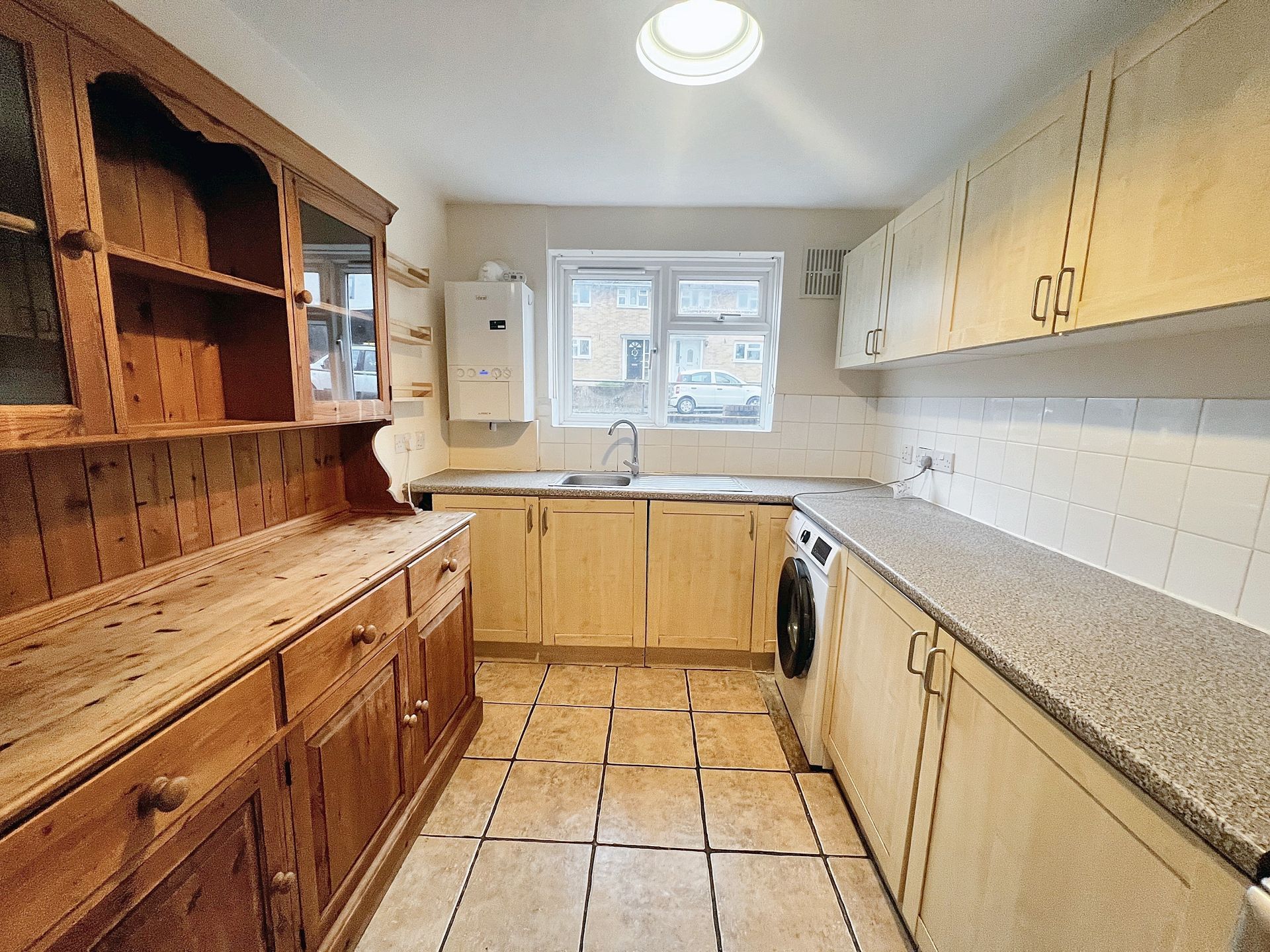 A kitchen with wooden cabinets and granite counter tops