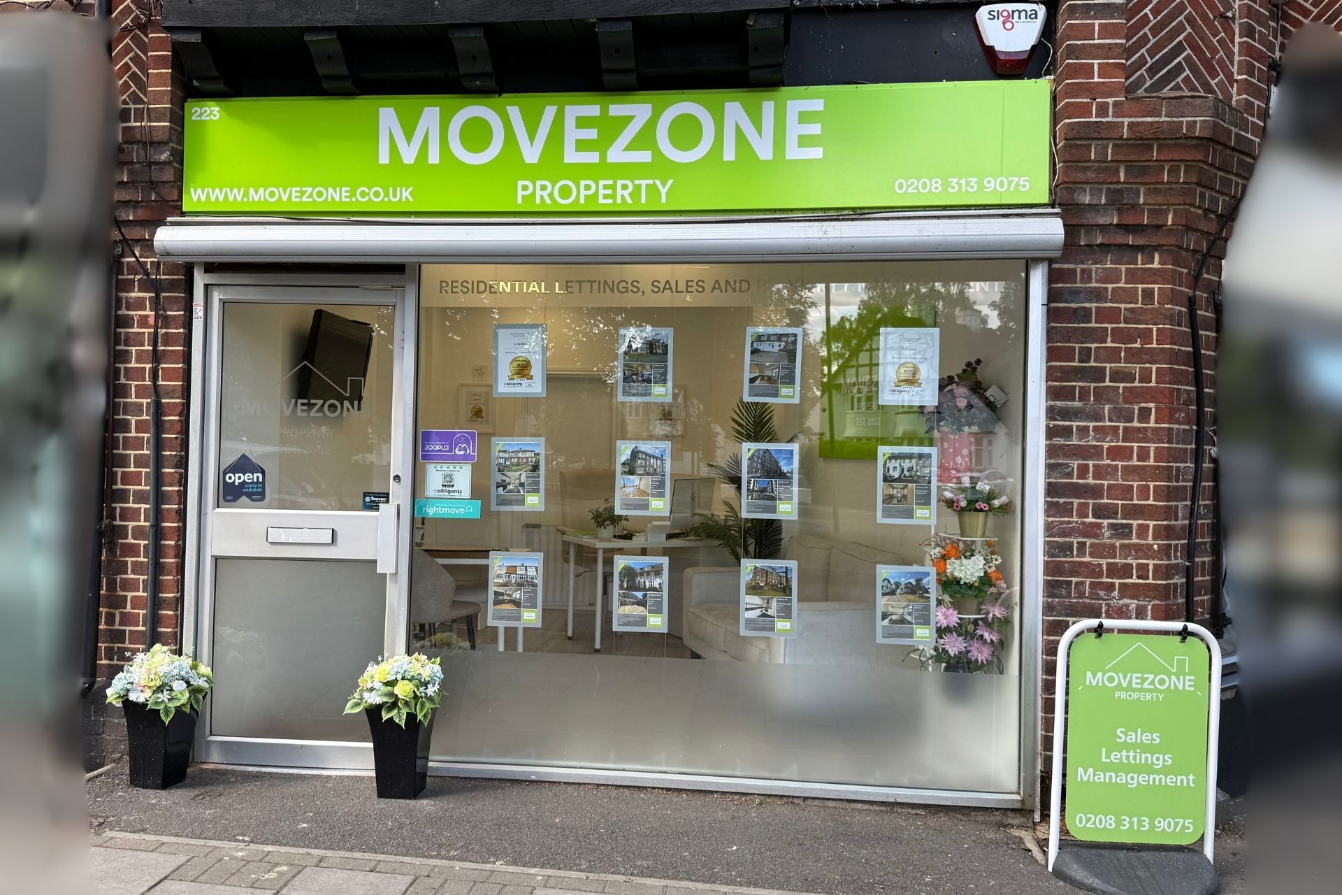 A group of people are putting their hands together on a wooden table.