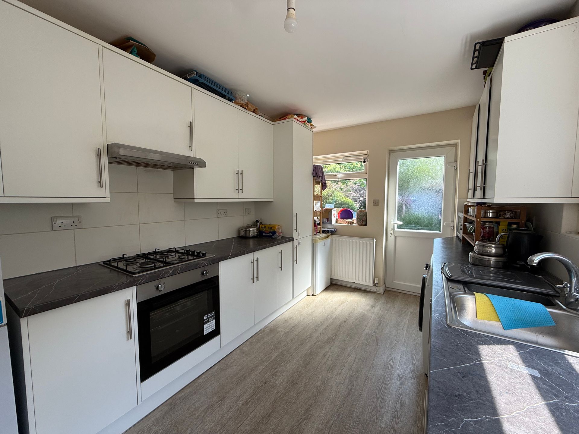 A kitchen with white cabinets and stainless steel appliances