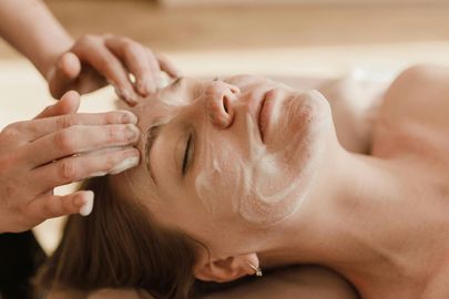 A woman is getting a facial treatment at a spa.