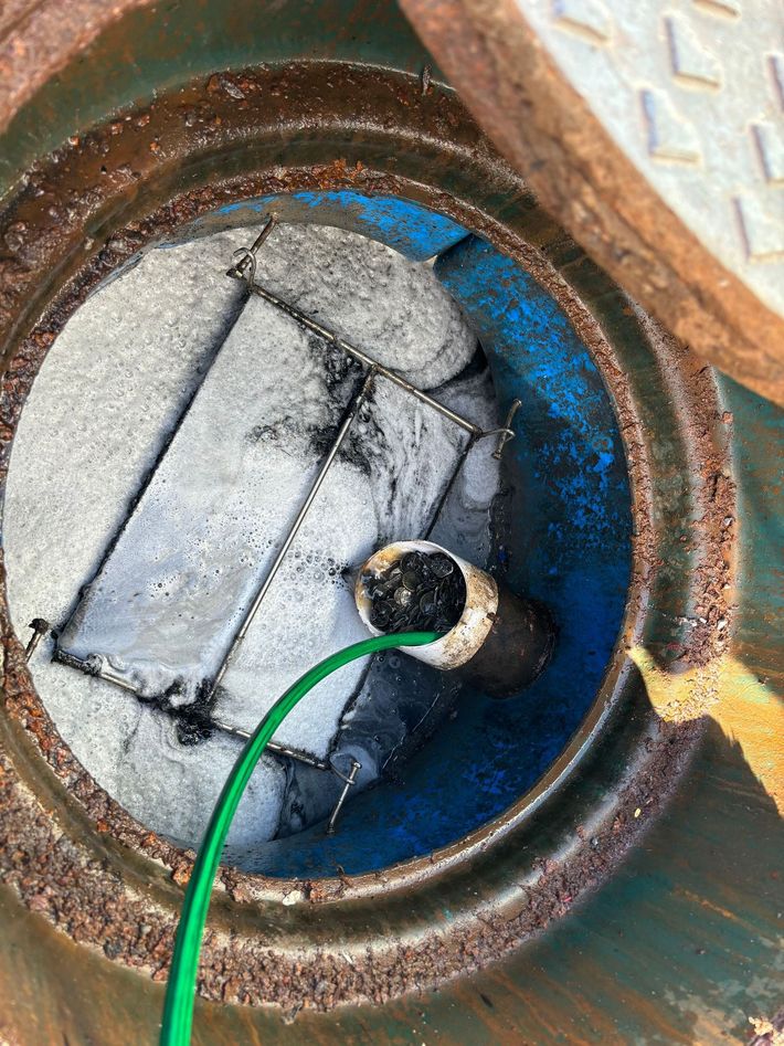 Blue Container With a Grey Device and a Green Cable — Gibson Plumbing & Roofing Pty Ltd in Gladstone Central, QLD