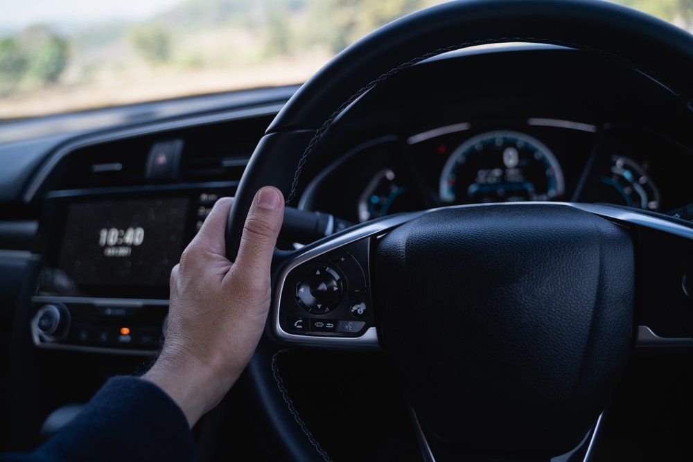 Close Up Of Hand Man Holding Steering Wheel In The Modern Car — B Wild Auto Repairs in North Gosford, NSW