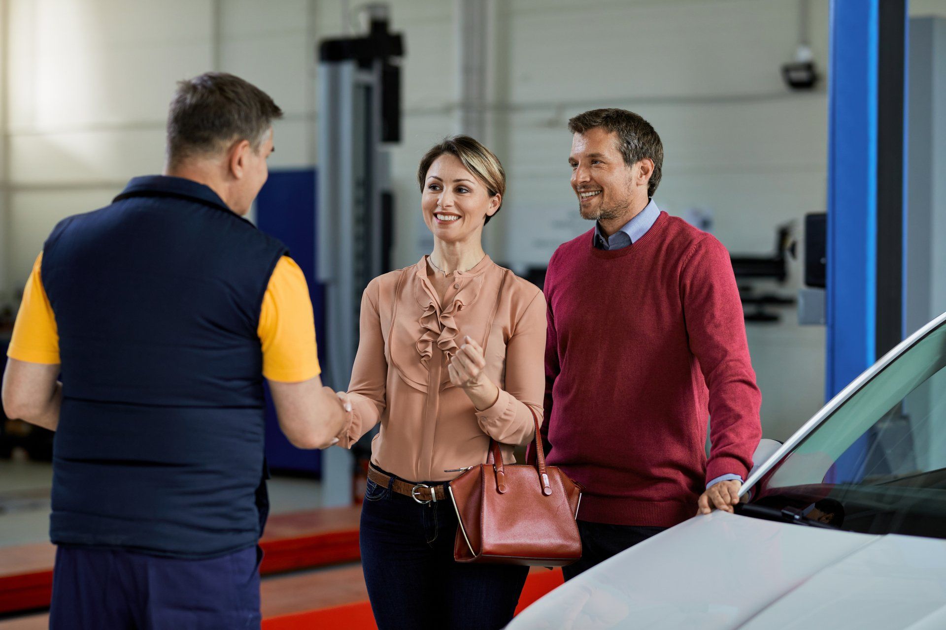 Businessman Shaking Hands With Mechanic In Auto Repair Shop — B Wild Auto Repairs in North Gosford, NSW