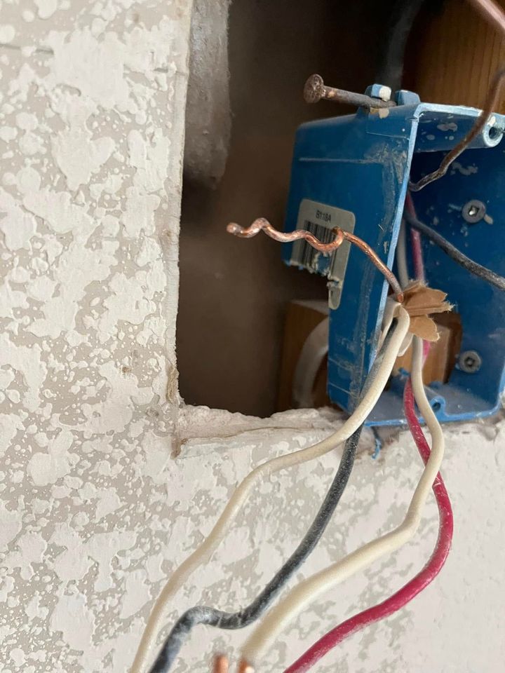 A close up of a box with wires coming out of it.