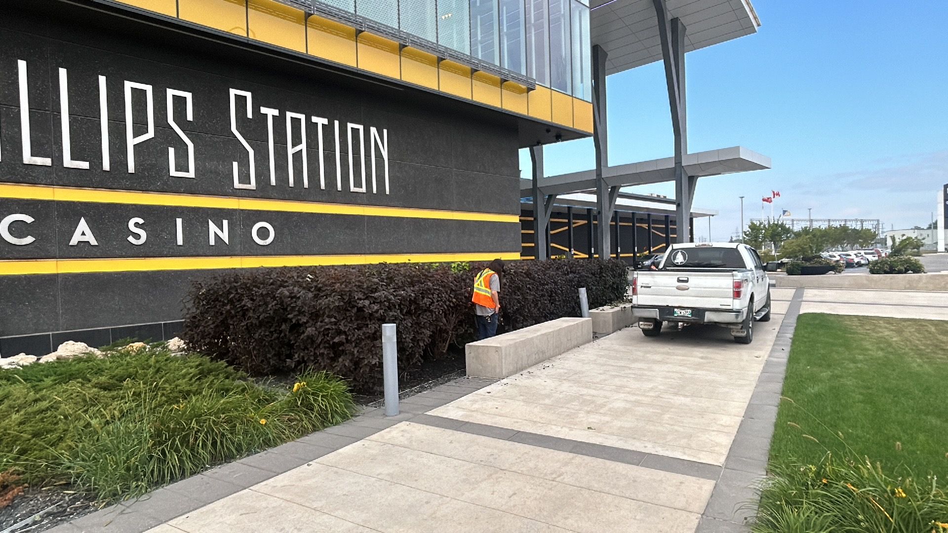 Hedge trimming being done outside of a casino in Winnipeg