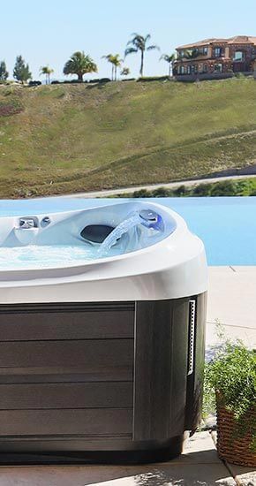 Un bain à remous est installé à côté d'une piscine.