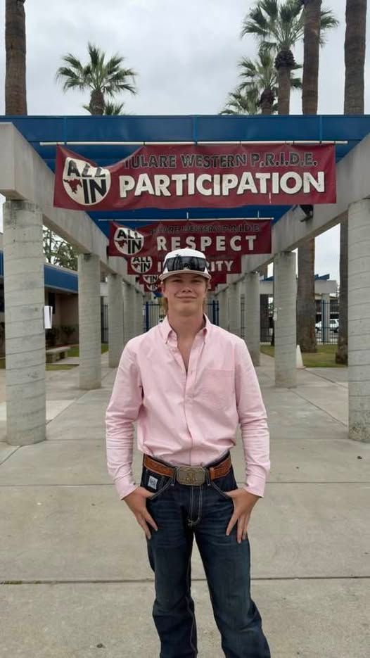 A man is standing in front of a sign that says participation.