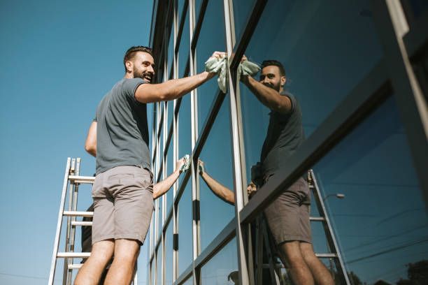 Man Cleaning the Window — Champaign, IL — Precision Maintenance