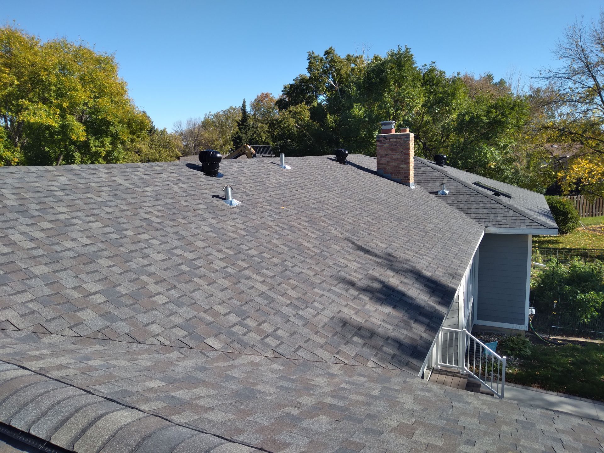 Impact Resistant Roof Shingles, Lomanco Turbines and Ridge Vents with a Velux Skylight in Moorhead, Minnesota