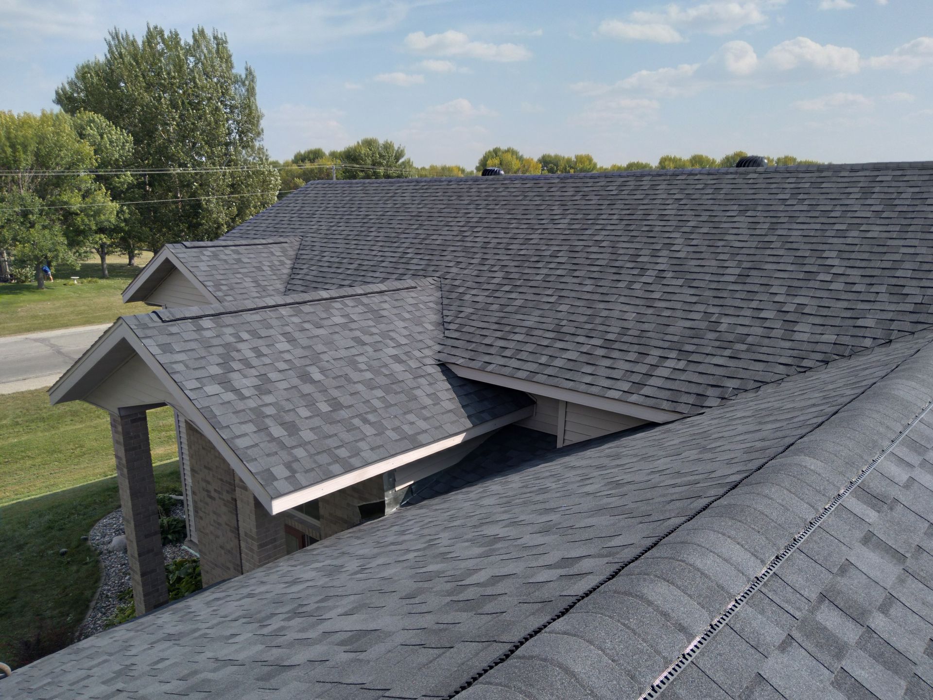 Reroofed house using Moire Black Colored Shingles with Ridge Ventilation in the Moorhead-MN; Fargo-ND area