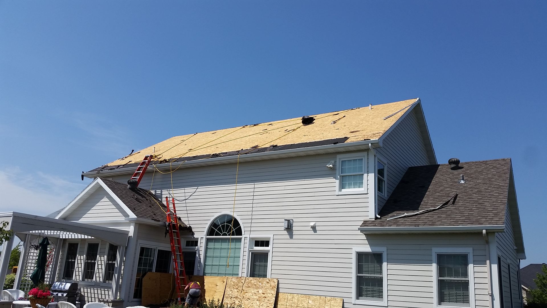 Ladders on Edge of Roof with OSB Decking Exposed in Felton, MN