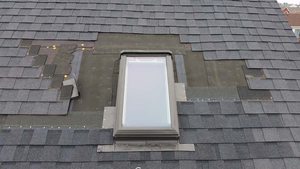 Existing Roof Skylight Flashing Being Repaired on a House in Lisbon-ND