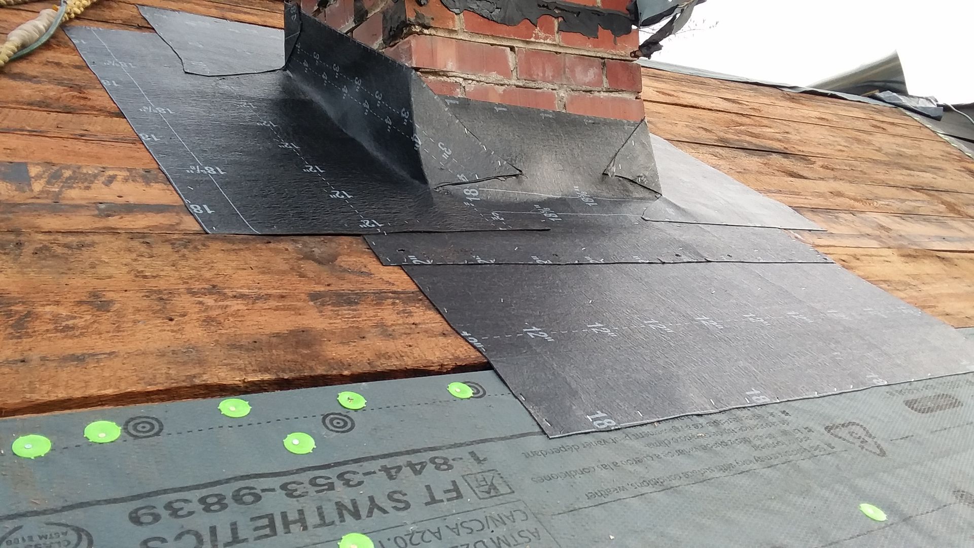Ice & Water Barrier pre-flashing on a Brick Chimney on top of Roof Felt Paper in Amenia, ND