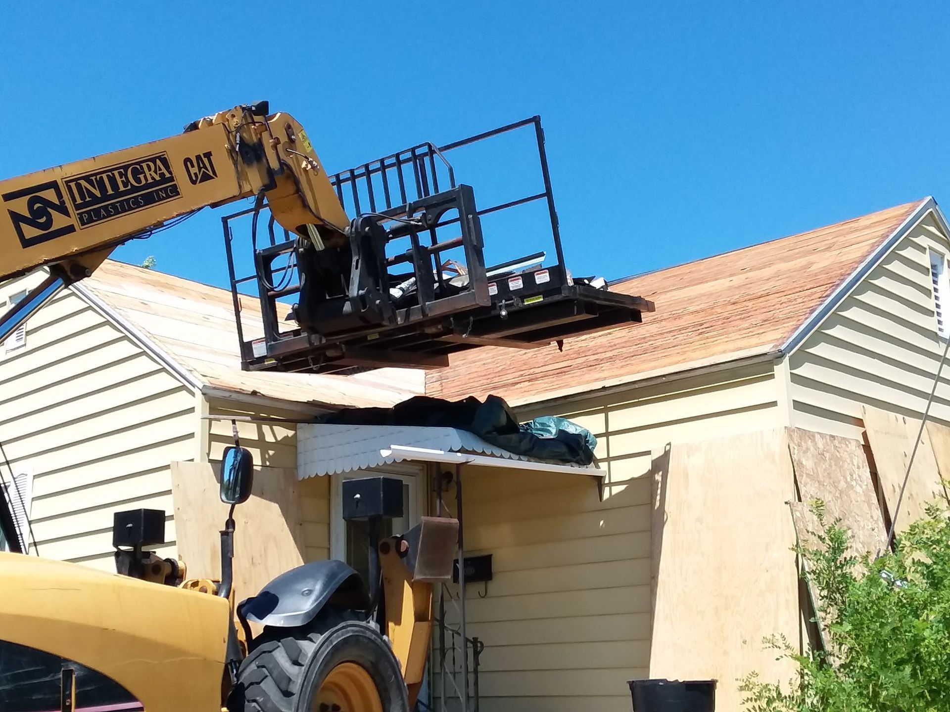 Roof decking stripped of asphalt shingle debris plus roofing felt and nails near Fargo-ND