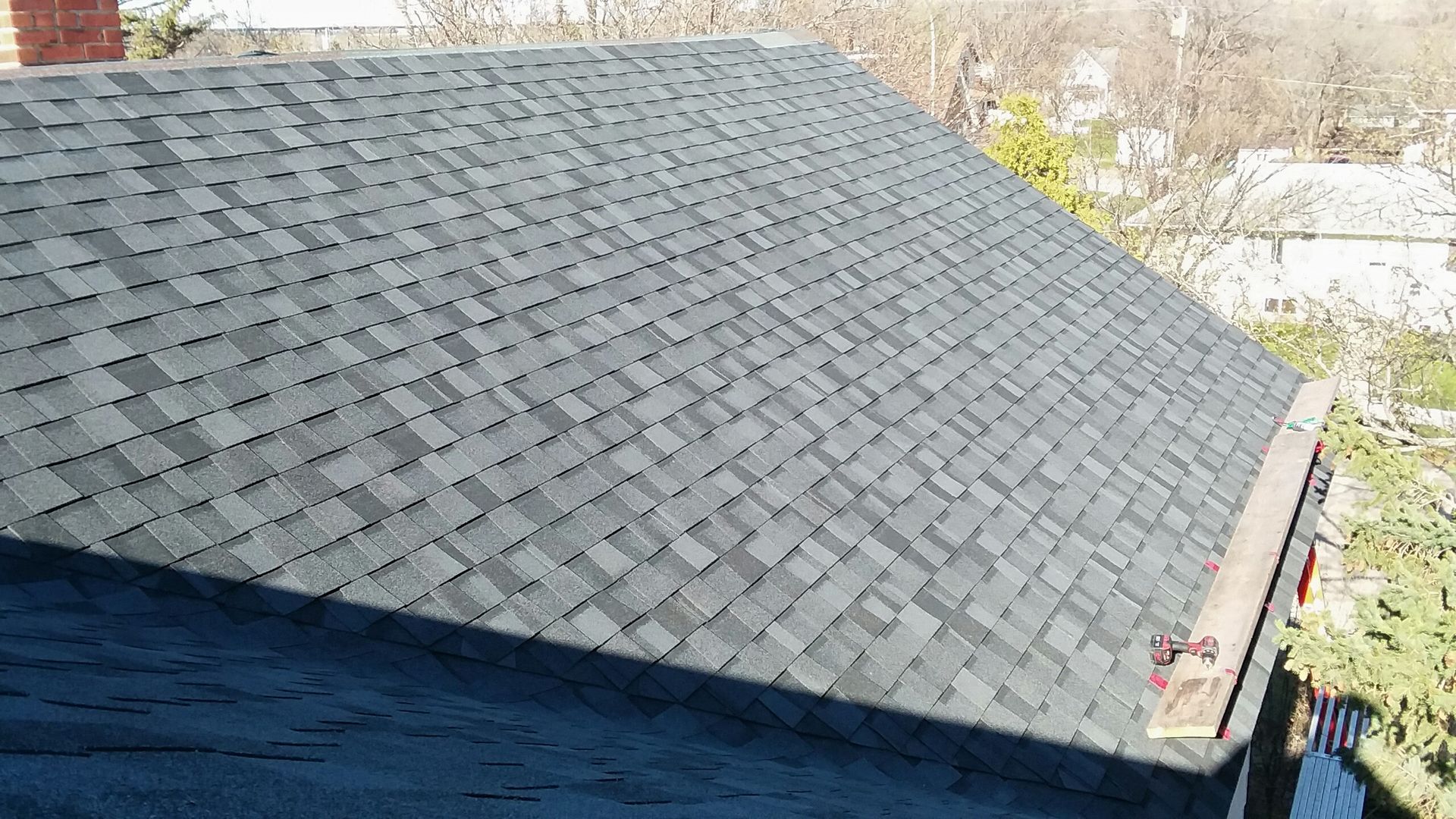 Near Finished Moire Black Roof in Mayville, ND with Safety Jacks on a 2nd Story House