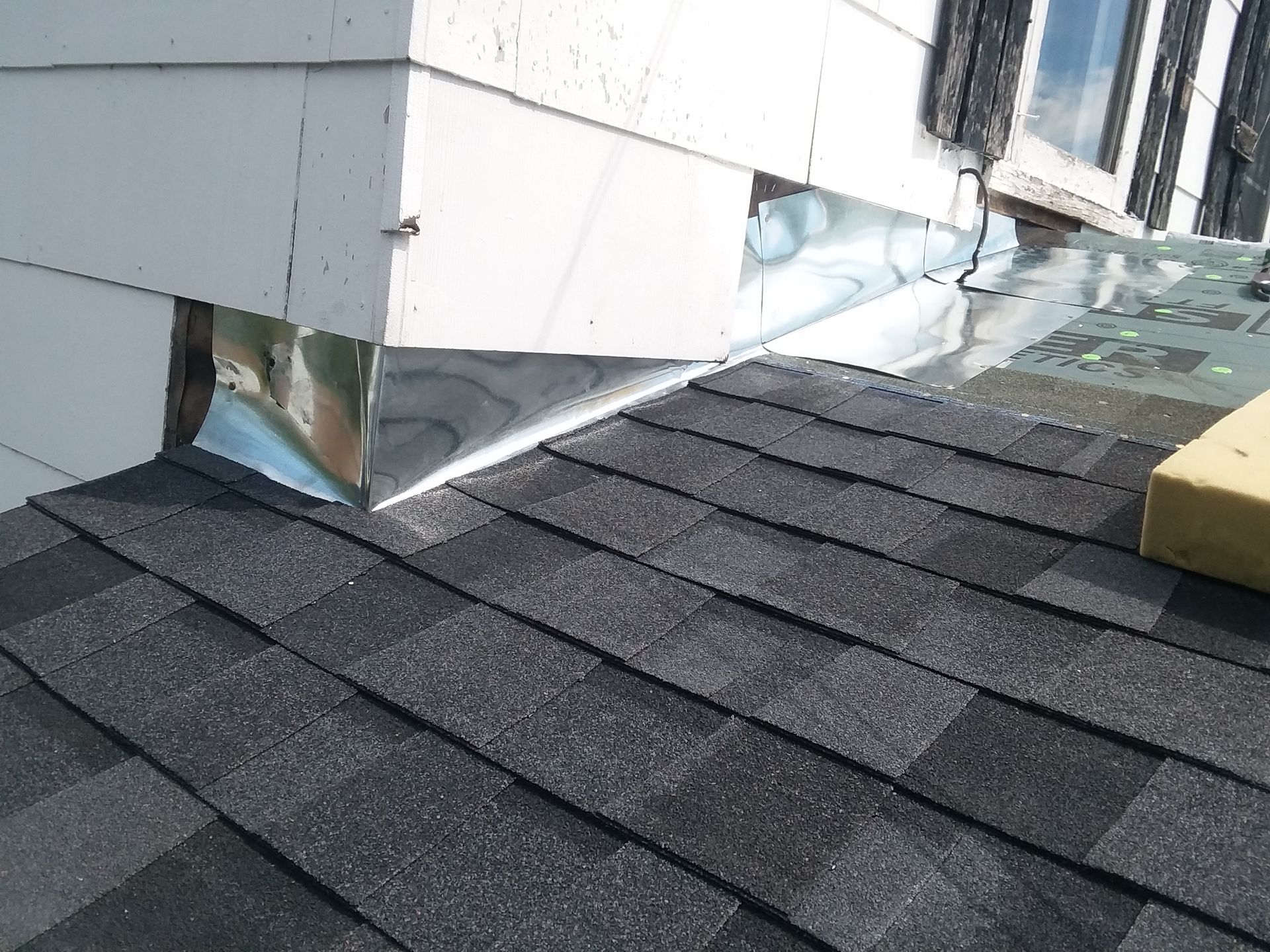Moire Black Shingles Installed with New Continuous Roof to Wall Flashing in Nome, ND