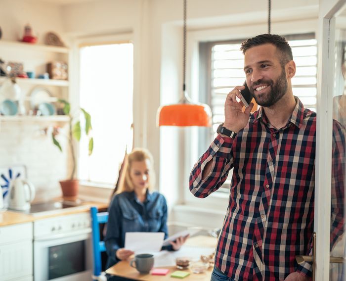 Homeowner calling a roofing contractor for an inspection and cost estimate near Fargo-Moorhead