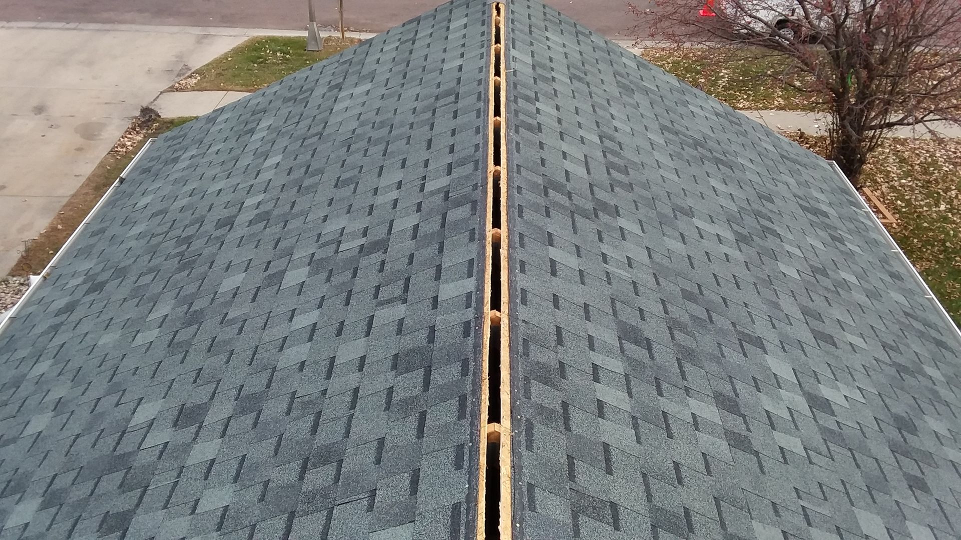 Ridge Vent Opening Cut on an Asphalt Shingle Roof Replacement in Rochert, MN