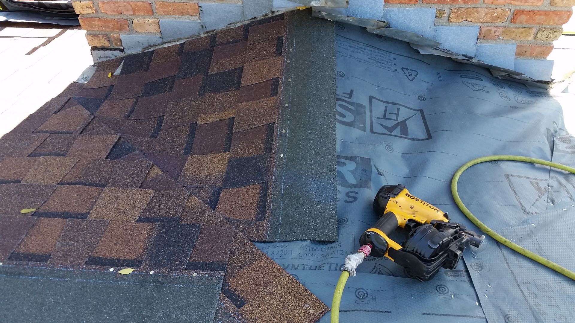 Shingles Being Installed by Chimney with Roofing Gun in Otter-Tail-County-MN