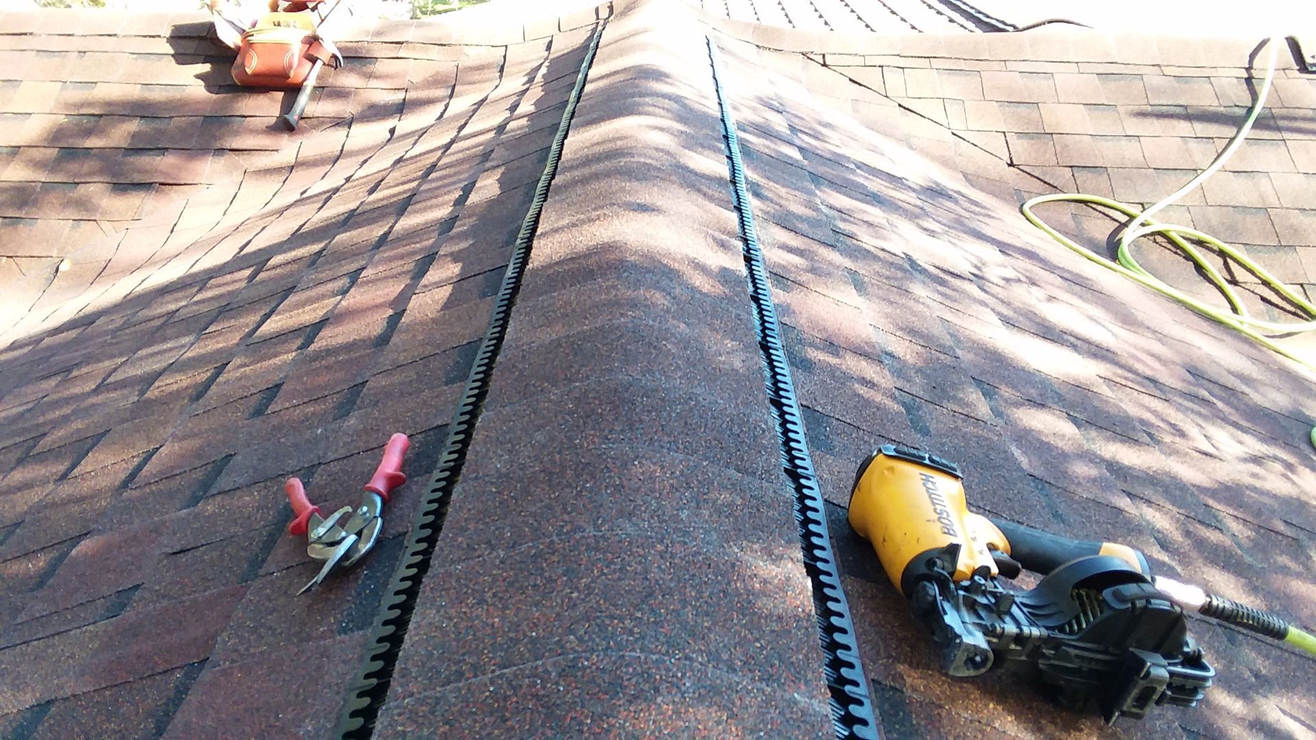 Tin Snips and Roofing Gun on a Roof with a Ridge Vent in Enderlin, ND