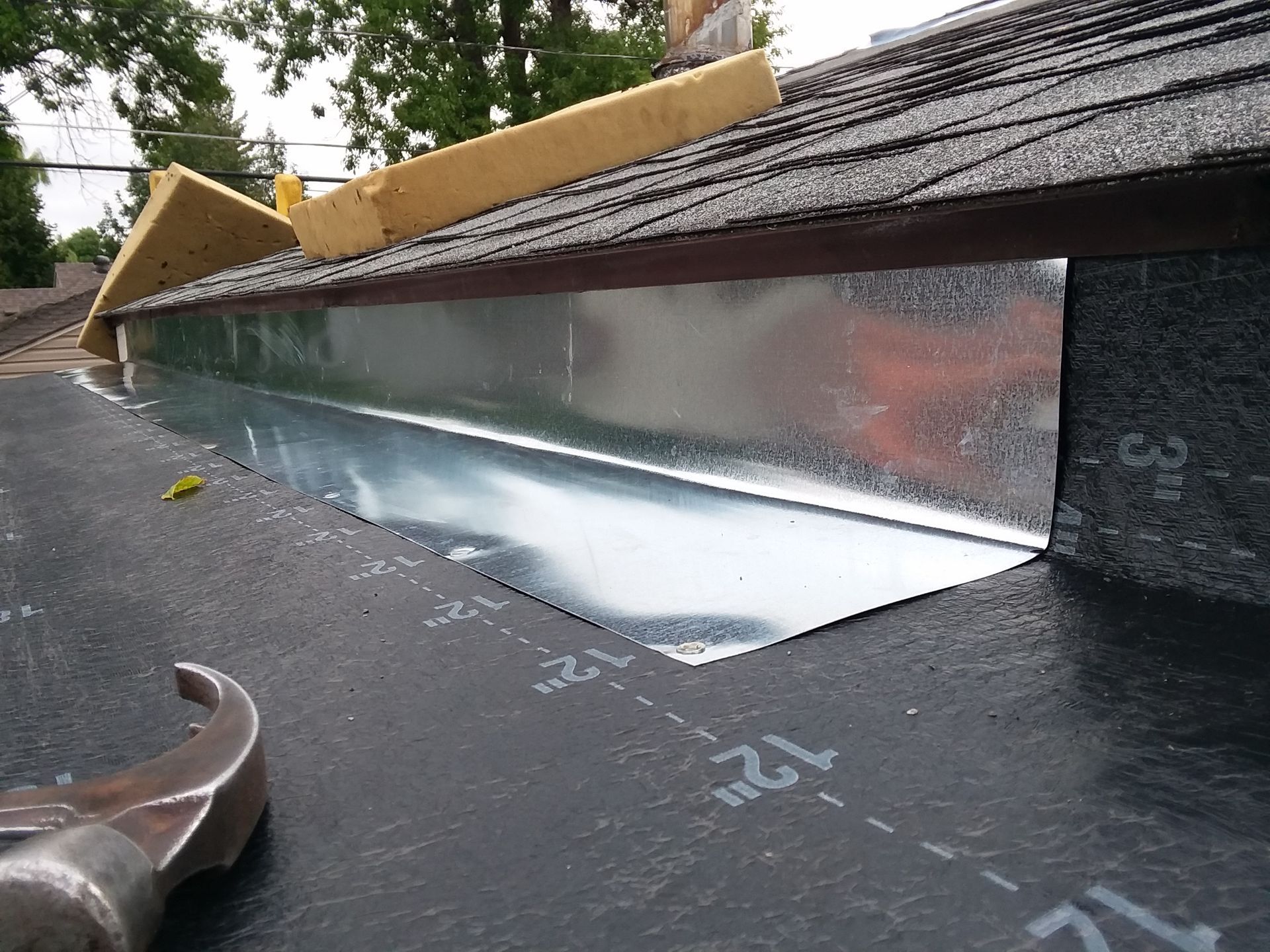 Metal Flashing under Drip Edge onto Rolled Roofing Base Layer on a Home near Wahpeton, ND