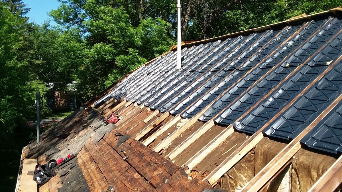 Attic Ventilation Baffles being Installed between Rafters with new roof decking in Shelly, MN