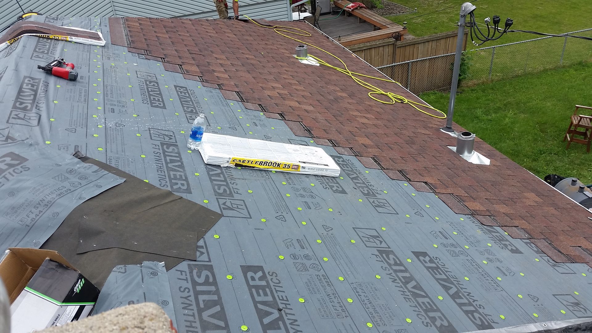 Burnt Sienna Colored Roof Shingles with Synthetic Roofing Felt with Bundle of Shingles in Perley-MN