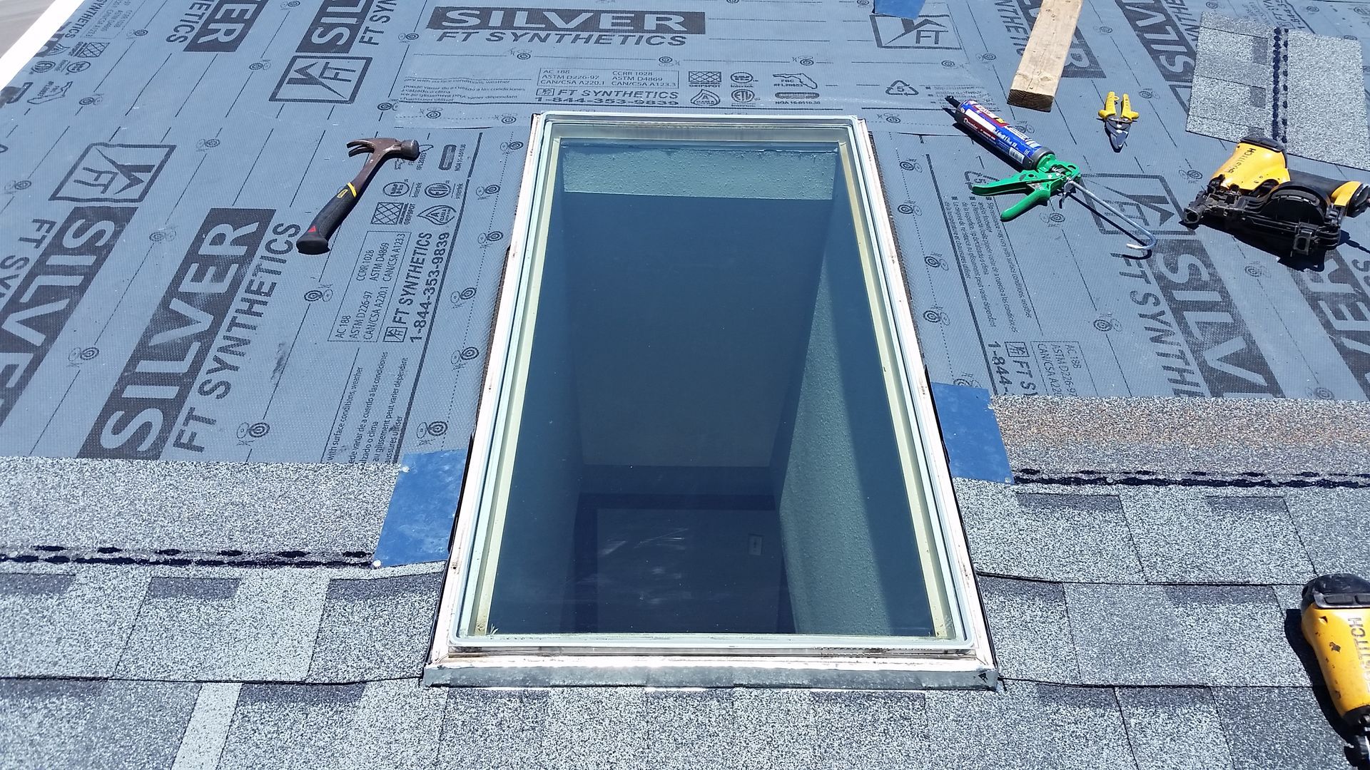 Roof Skylight Flashing being Weaved into New Shingles on a Home near Cormorant, MN