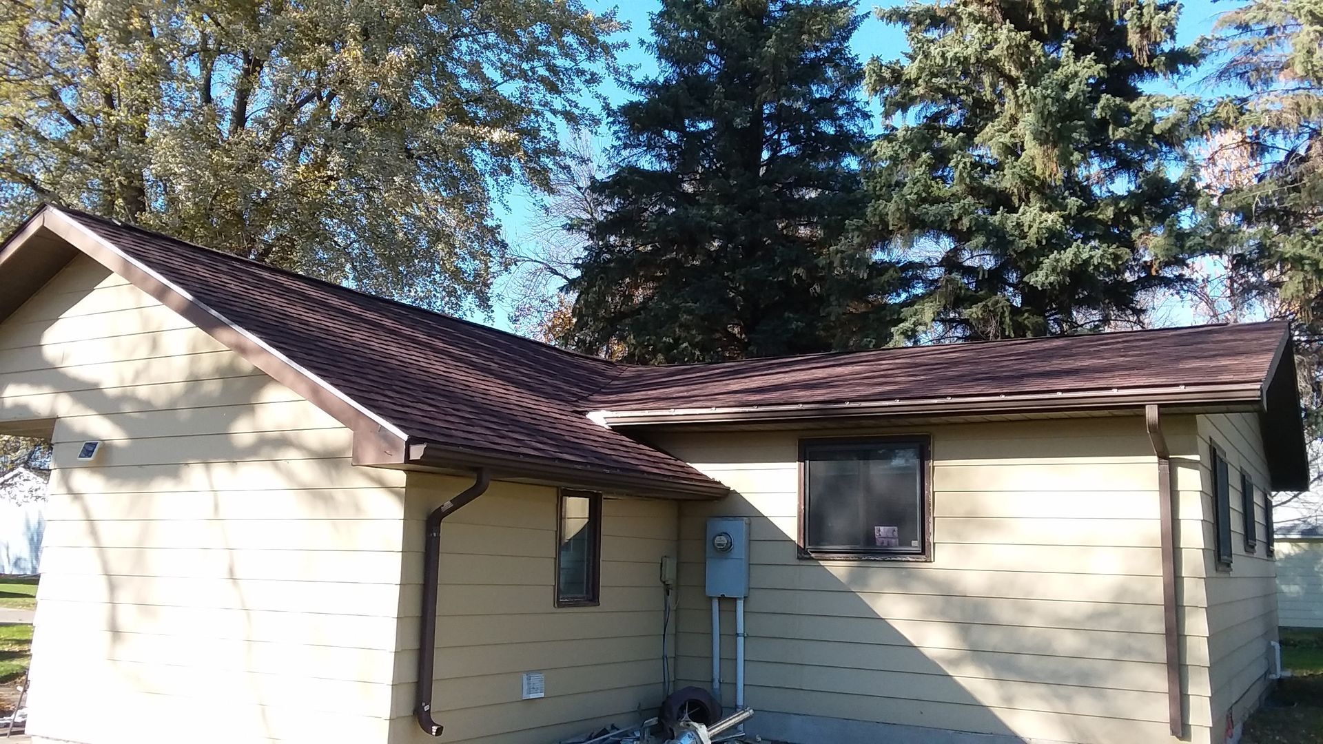 Back of house completed with Atlas Castlebrook Burnt Sienna Shingles near Portland, ND