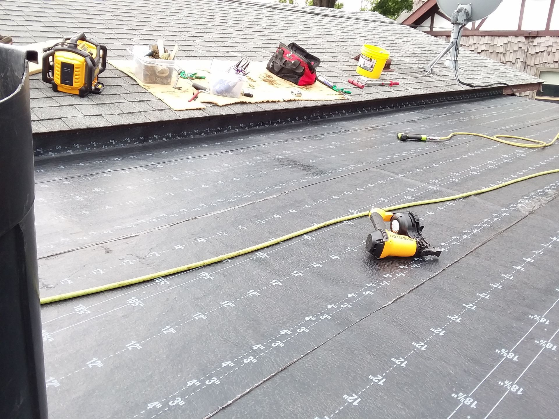 Roofing Tools Sitting on Roof and Self Adhered Base Layer Installed near Kindred, ND
