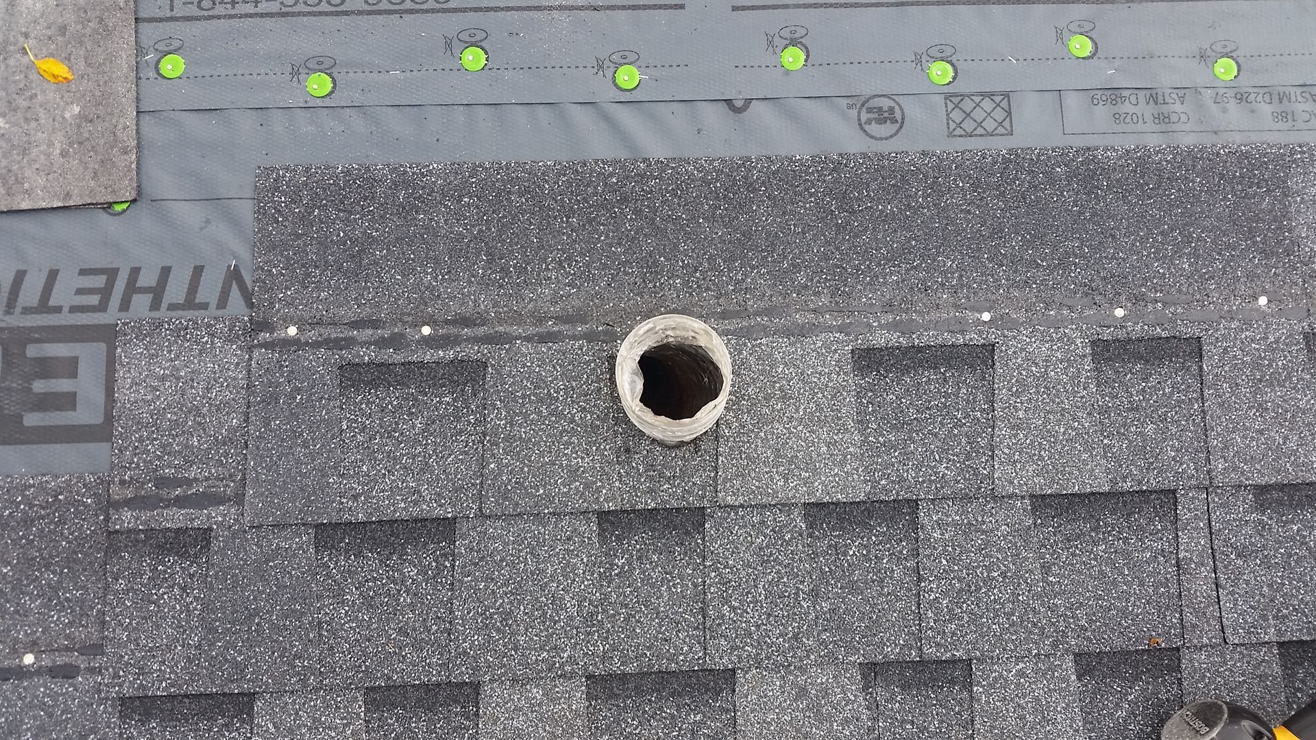 Architectural Shingles Nailed to Roof with Hole Cut for Fan Duct Vent in Richland-County-ND