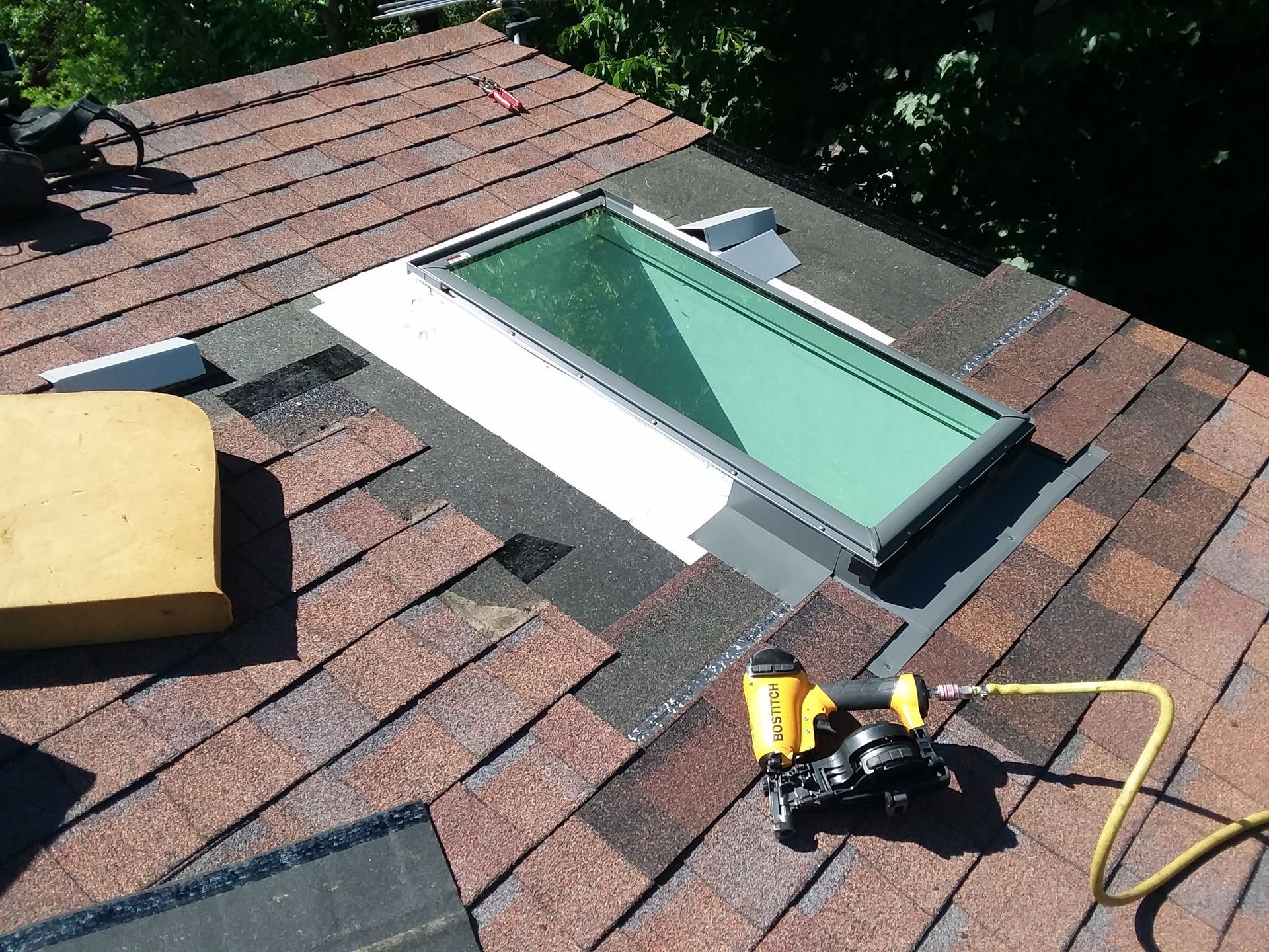 Leaking skylight roof window replaced using a new metal flashing kit, pneumatic tool and hand tools near Fargo-Moorhead