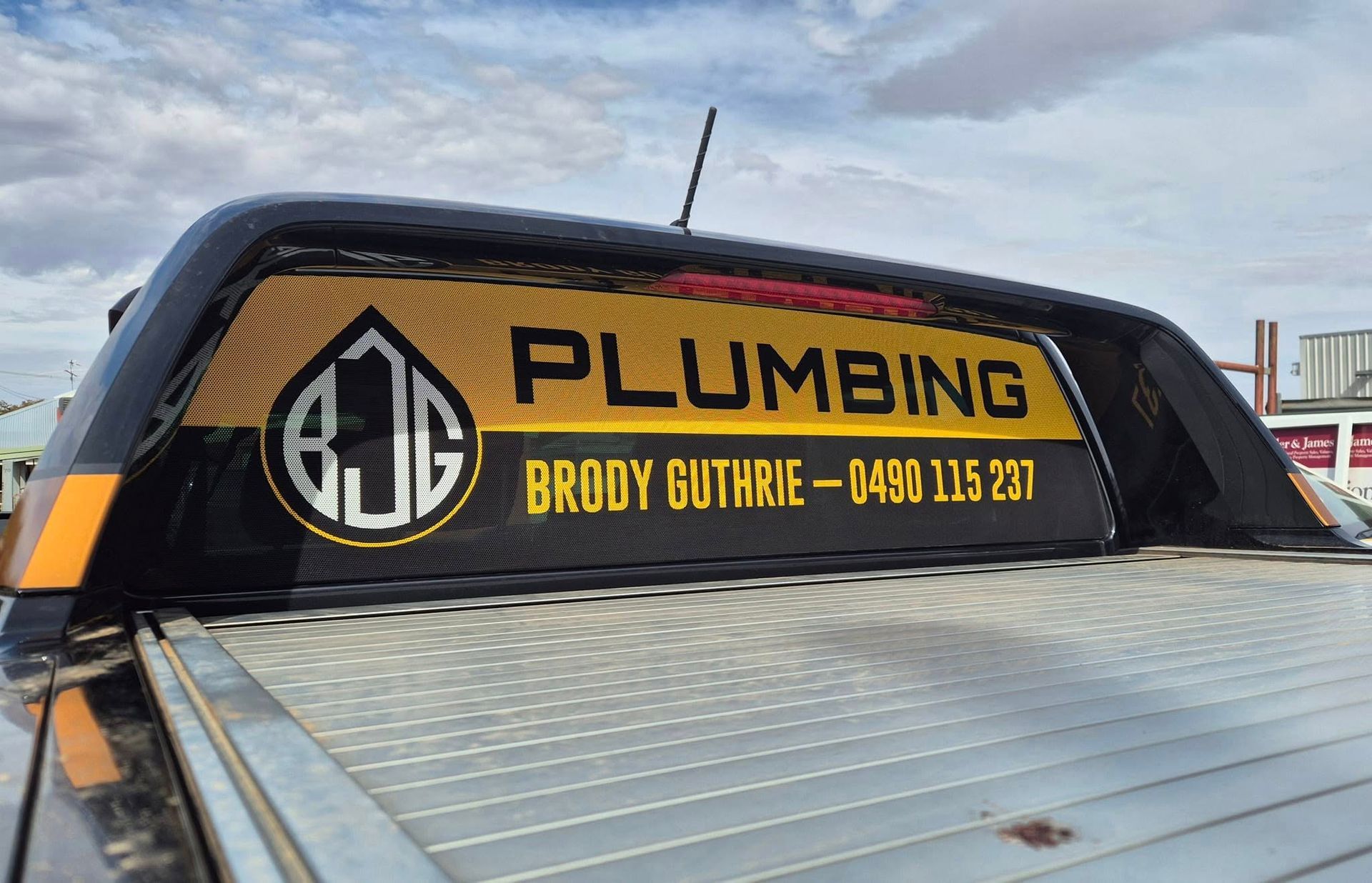 Black truck rear window with yellow