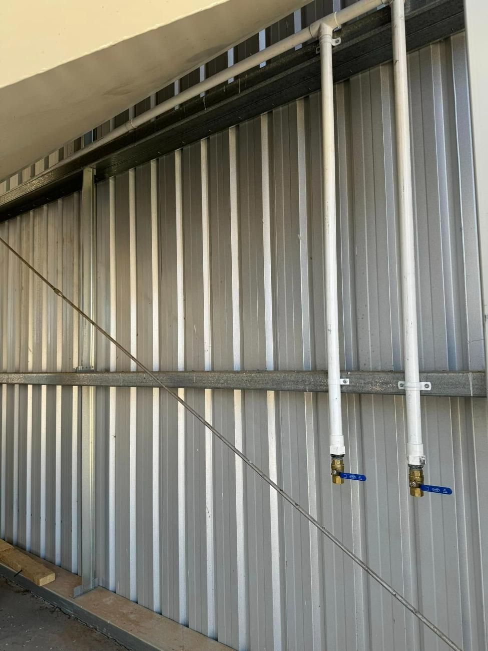 White Pipes With Blue Valves — BJG Plumbing in Ganmain, NSW