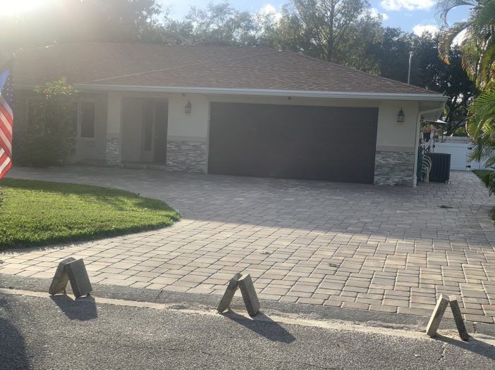 A house with a garage and a flag in front of it