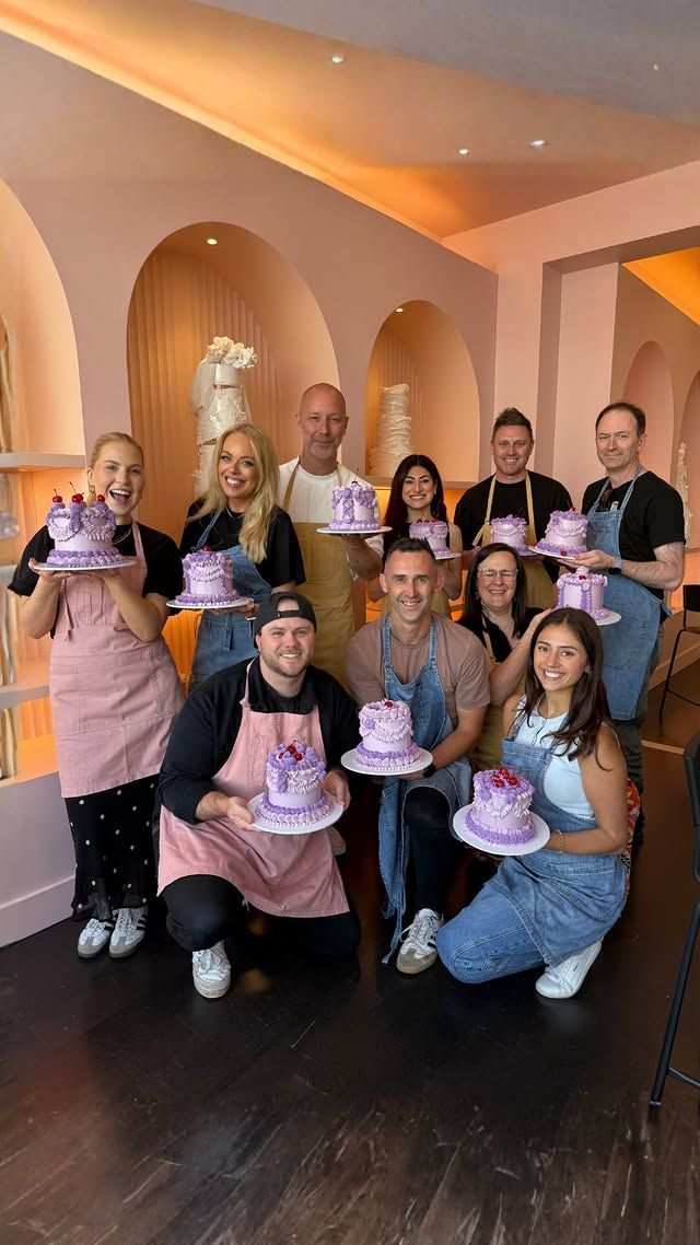 Boy and girl looking at a blue screen display in a science center exhibit. Other people in background.