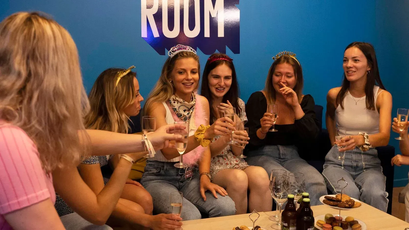 Boy and girl looking at a blue screen display in a science center exhibit. Other people in background.