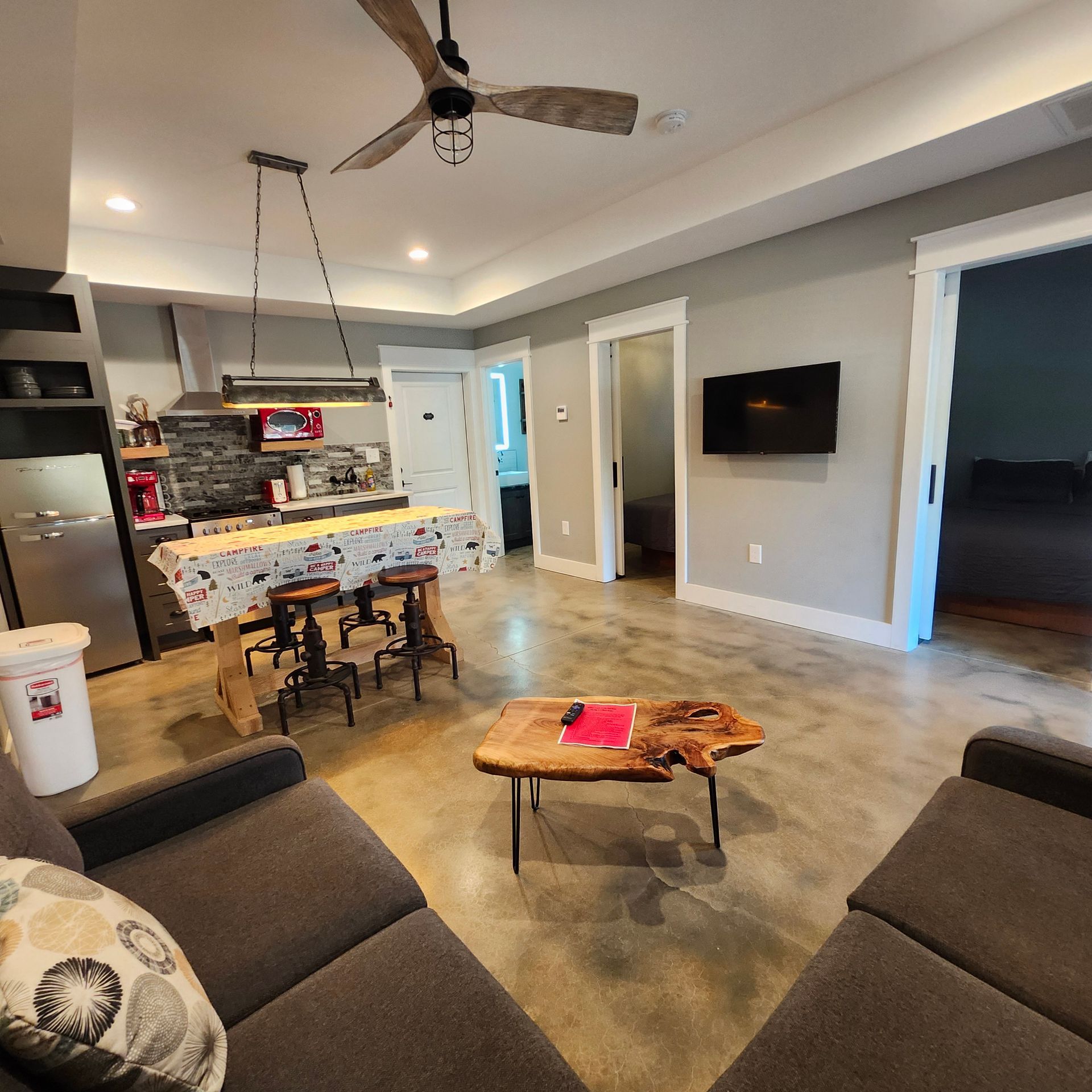 A living room with a couch a table and a television
