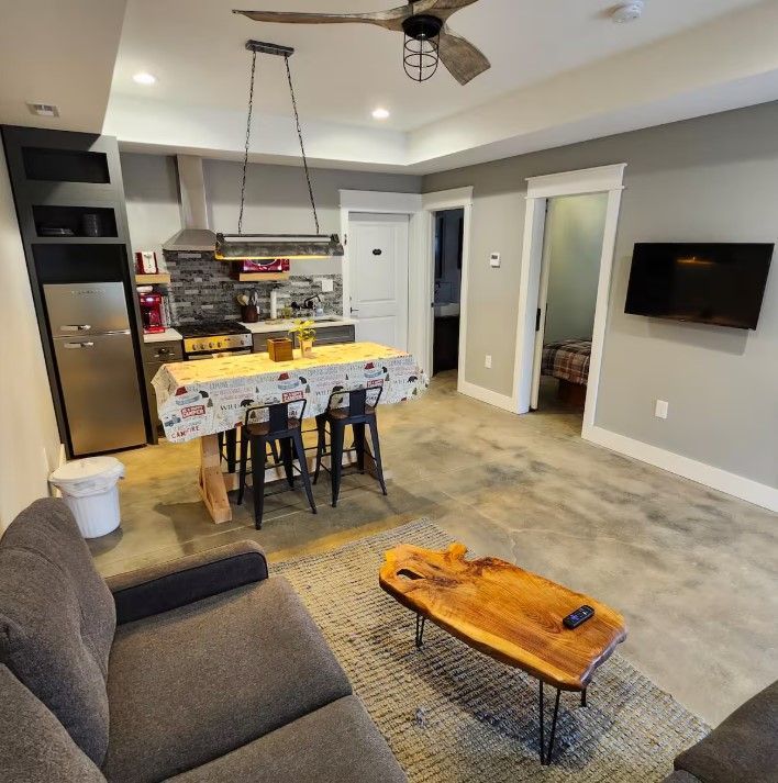 A living room with a couch a table and a television