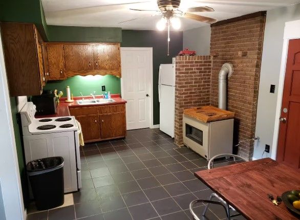 A kitchen with a table and chairs and a stove