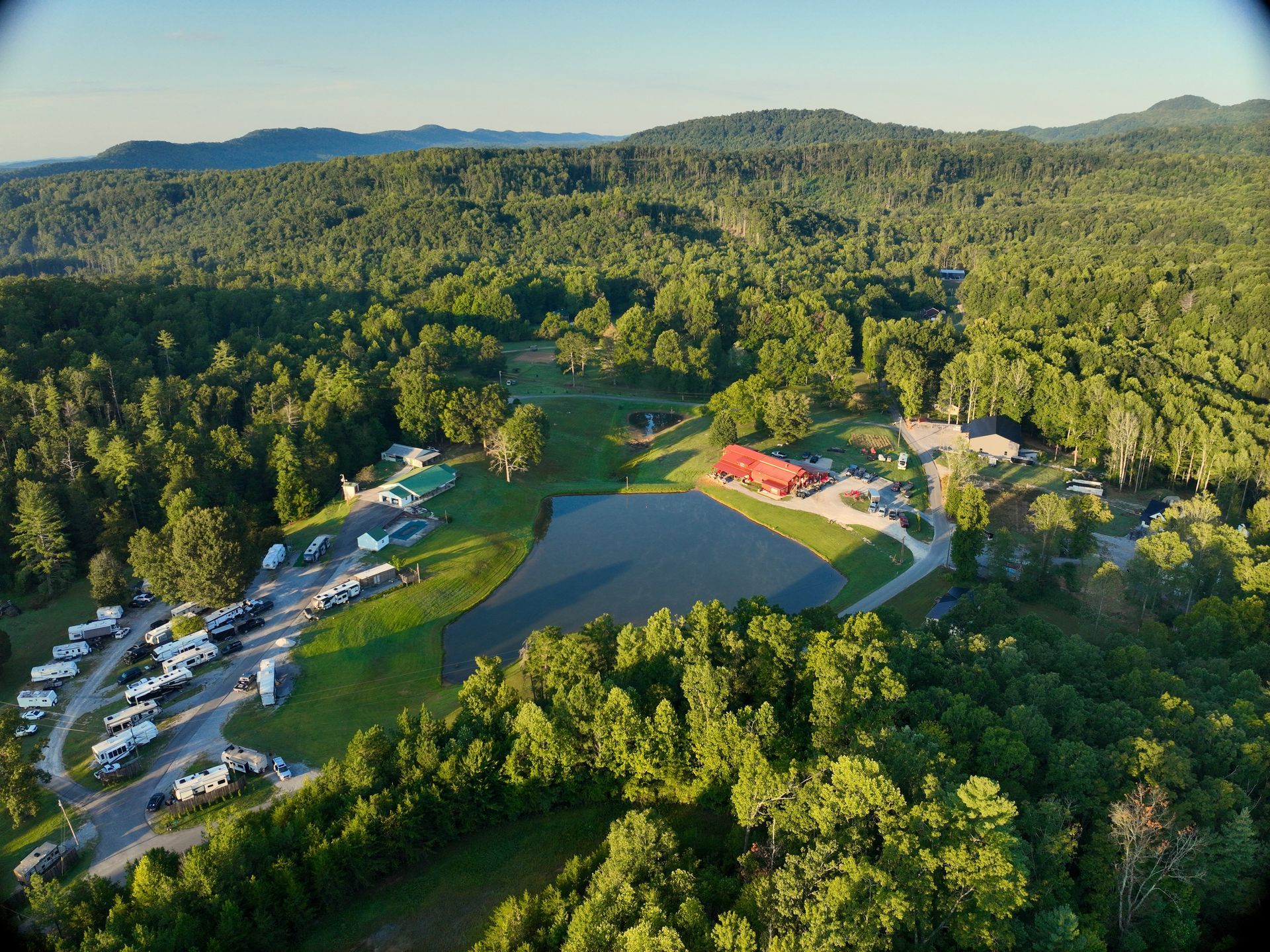 An aerial view of a rv park with a swimming pool.