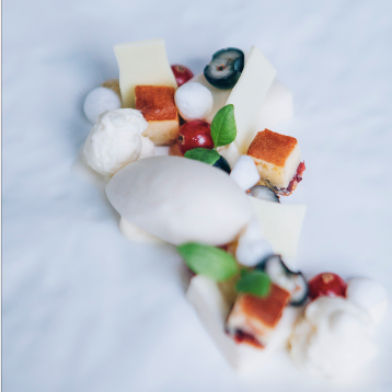 Een wit bord met daarop allerlei soorten eten, waaronder ijs