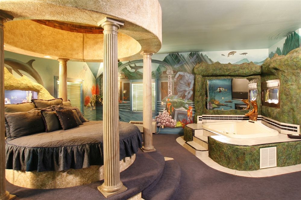 A room with a bed and a jacuzzi in it