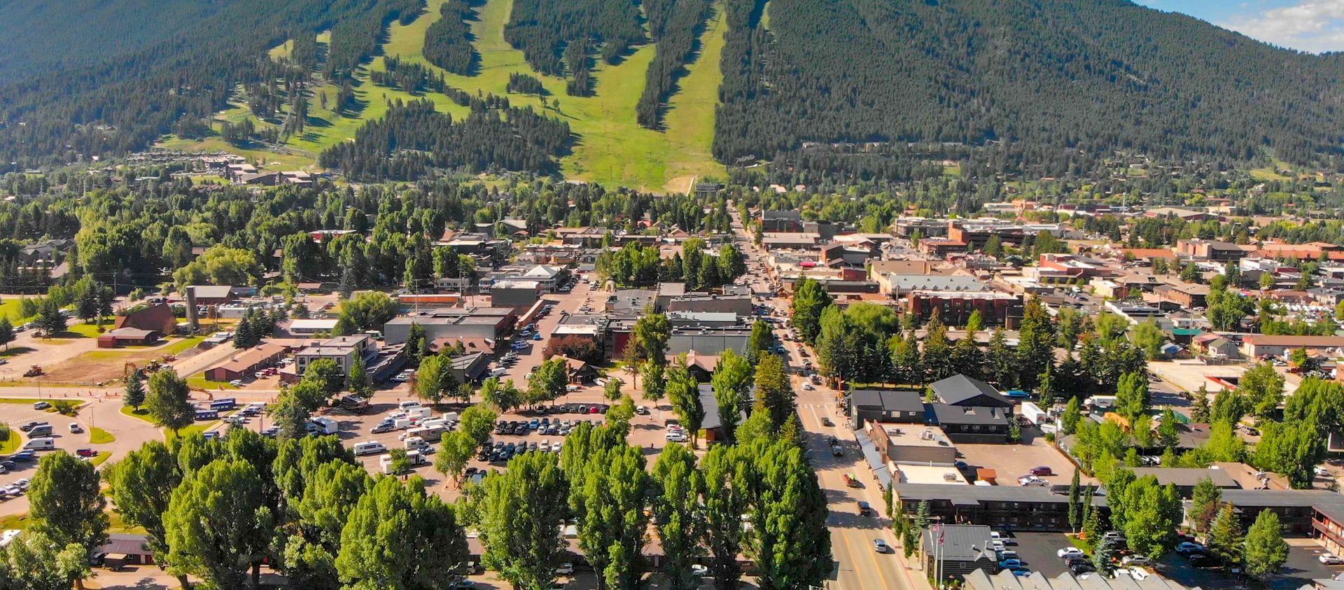 An aerial view of a small town with a mountain in the background.