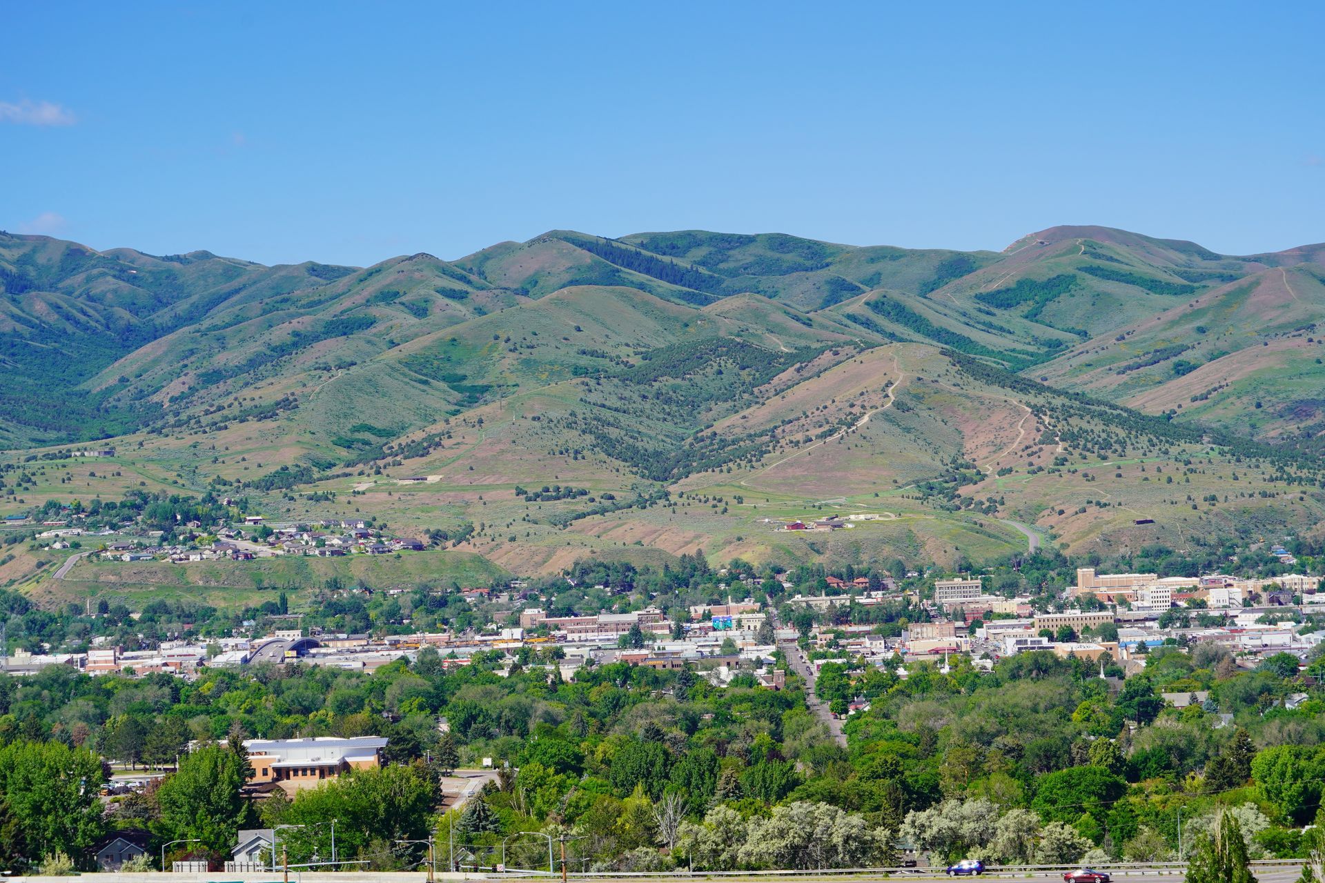 An aerial view of a city with mountains in the background.