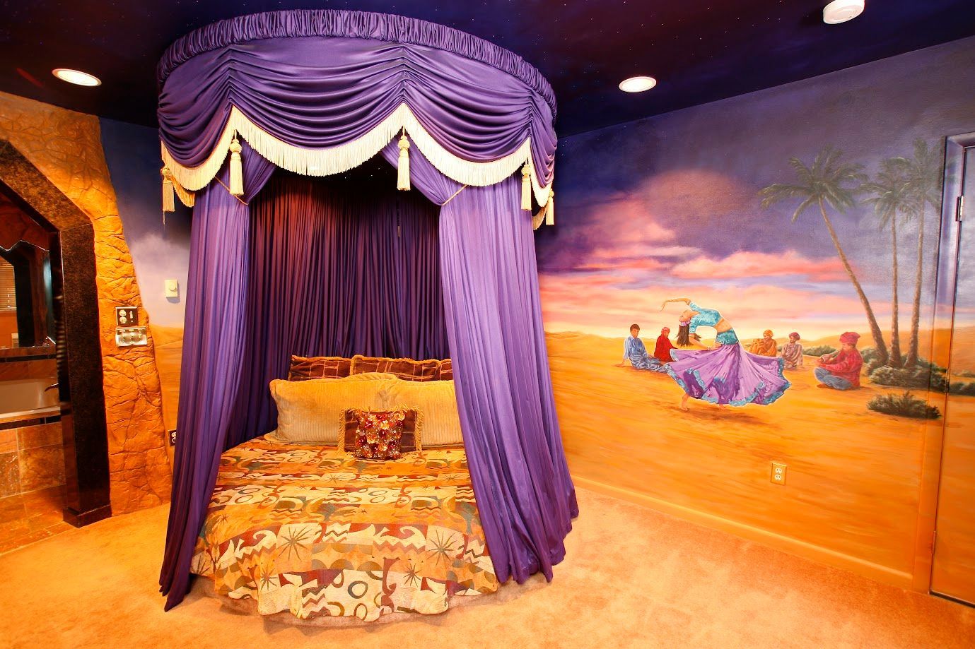 A bed with a purple canopy in a room with a painting on the wall.