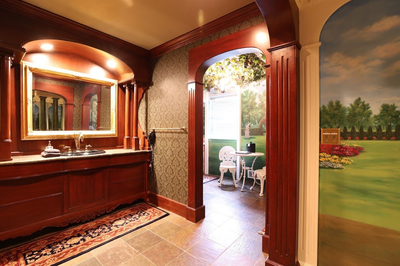 A bathroom with a large mirror and a painting on the wall.