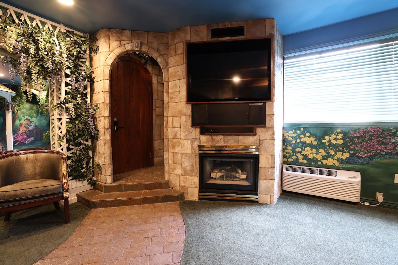 A living room with a fireplace and a flat screen tv