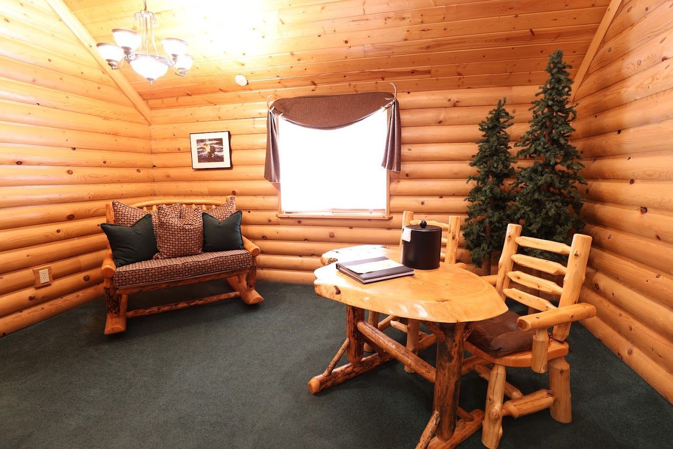 A log cabin with a table and chairs in it