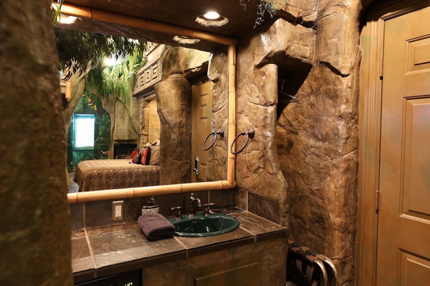 A bathroom with a sink and a large mirror.